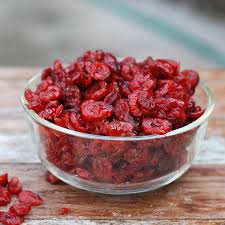 glass bowl on table of dried cranberries